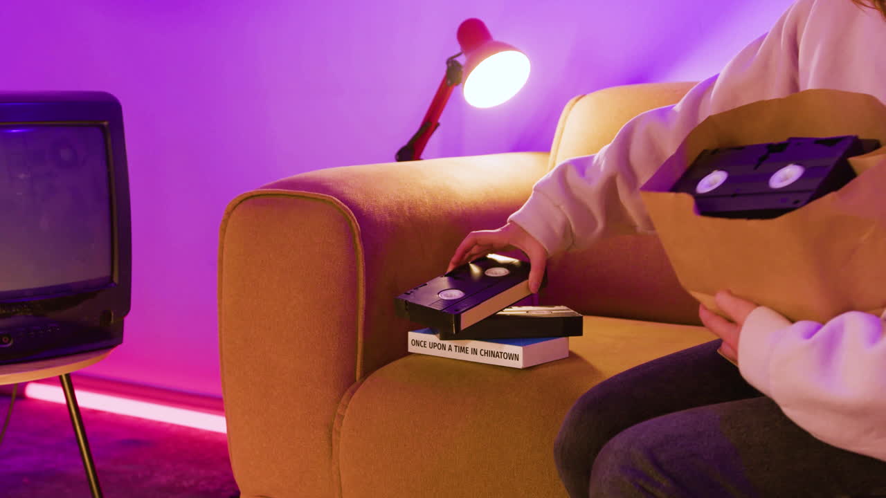 Living room with sofa, televisi&oacute;n and VHS cassettes