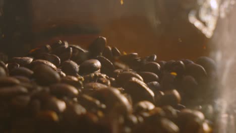 whole brown roasted coffee beans in glass jar falling in slow motion with bright natural sunlight. close up fresh hot drink ingredients ready to blend background.