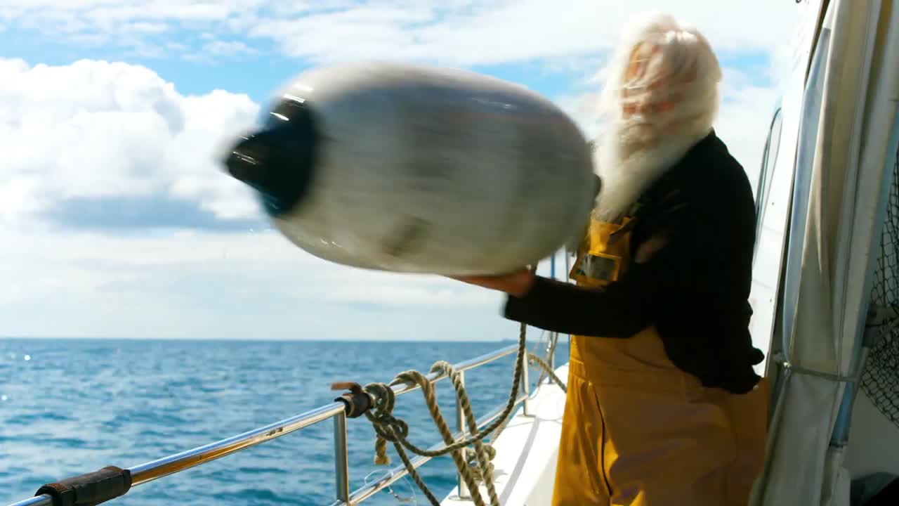 Fisherman removing a buoy into the sea