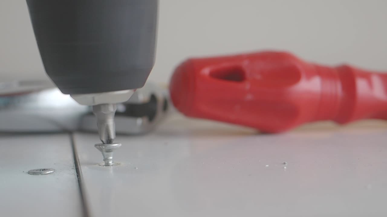 Drilling a Screw with a Power Drill and Screwdriver