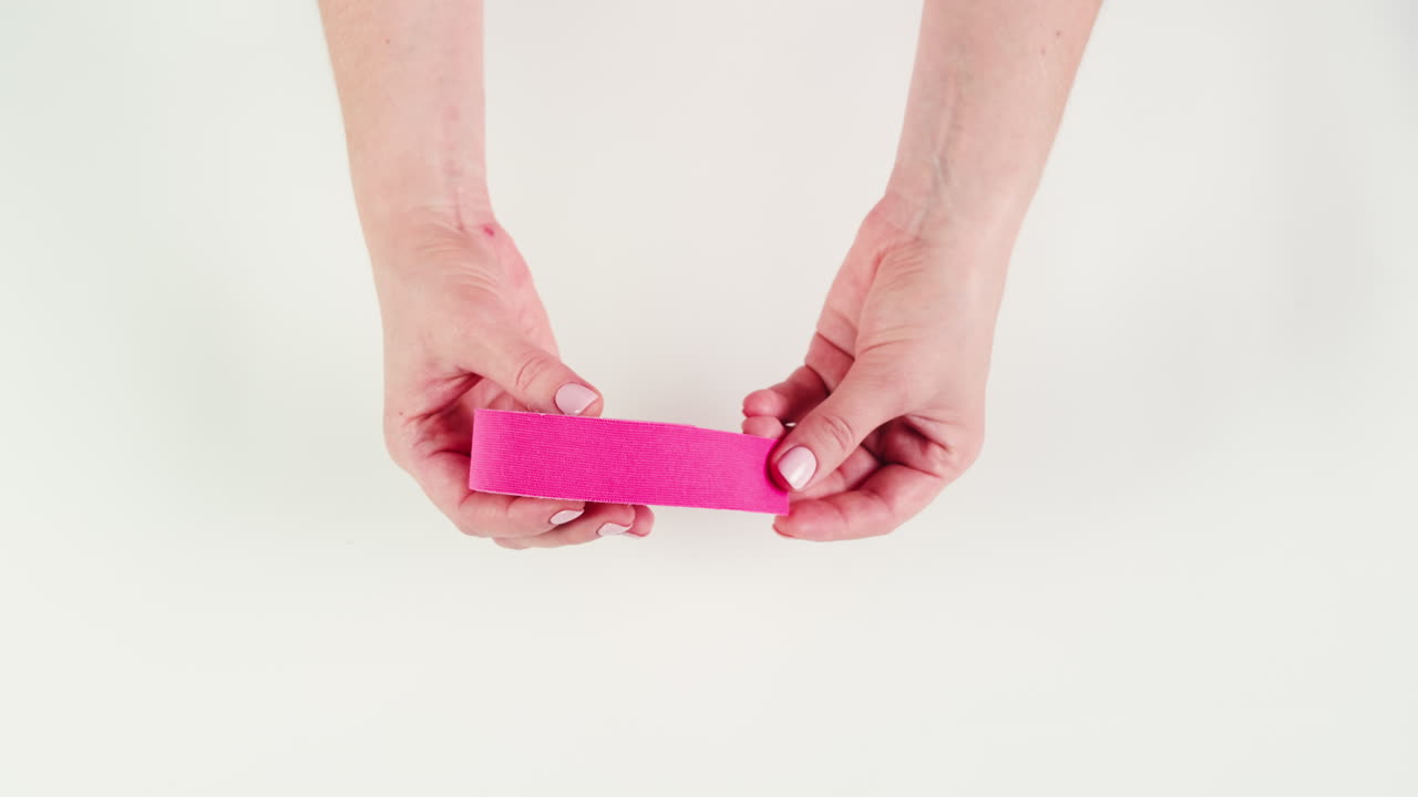 Kinesiology medical taping, doctor Physical therapist applying elastic surgical tape to patient body, treating injured knee young athlete.Post traumatic rehabilitation, sport physical therapy recovery