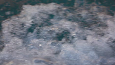 A-closeup-view-of-splashing-water-of-wave-from-the-boat-as-it-moves-through-water