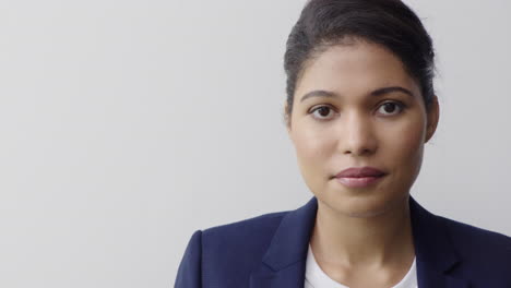 portrait of beautiful young business woman looking at camera professional hispanic female on white background