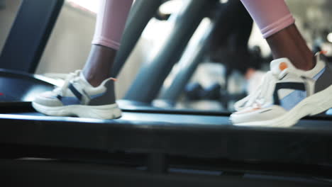 Fitness,-shoes-and-a-person-walking-on-a-treadmill