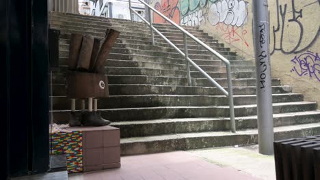 empty steep stairs are seen on a narrow car-free zone street