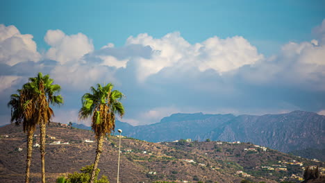 clouds forming and blooming above mountains, time-lapse