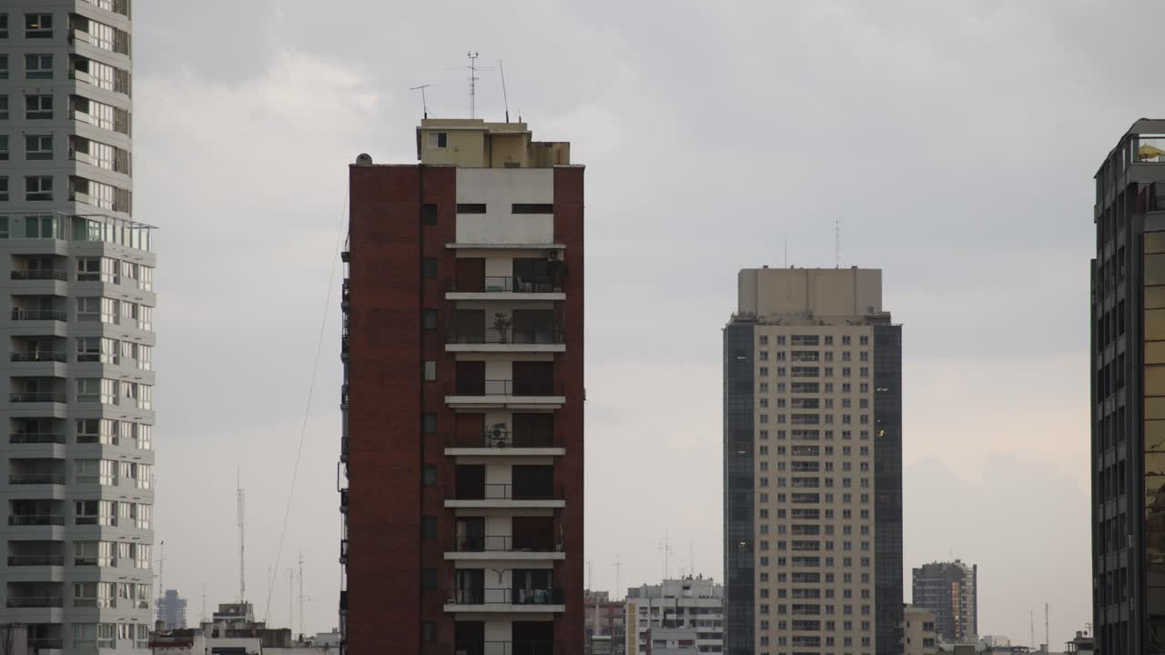 Urban skyline with tall buildings under a cloudy sky in Buenos Aires