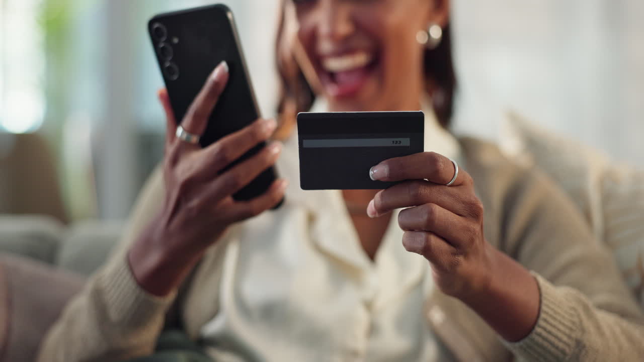 Woman using credit card and smartphone for online shopping