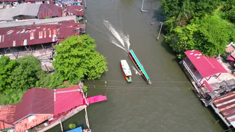 tour boats cruising on chao phraya river canal in bangkok, thailand - aerial pan up