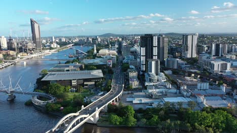 drone pull away shot of william jolly bridge, with south bank, west end and brisbane cbd and river all in shot