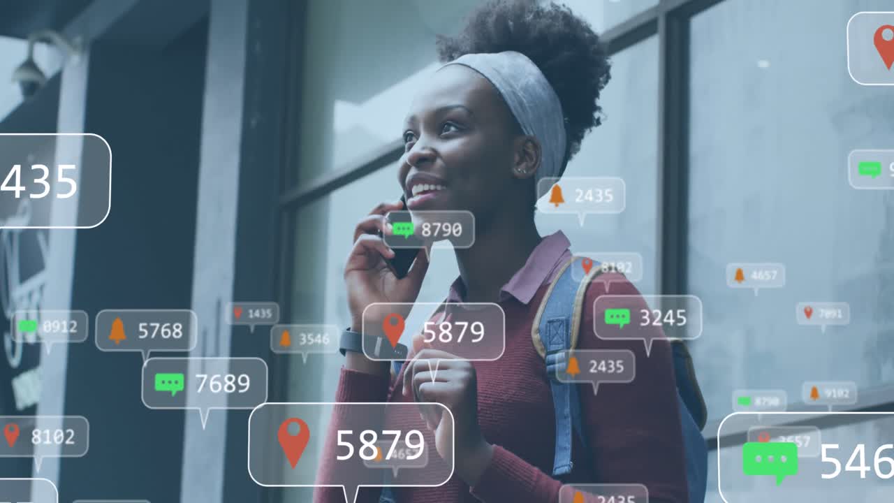 Animation of social media networking icons over african american talking on smartphone outdoors