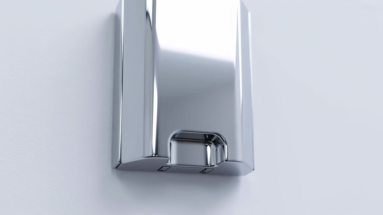 Kromfärgad väggmonterad dispenser med polerat rektangulärt hölje, rundade kanter och nedre trycköppning på framsidan, visas i en ren, modern badrumsmiljö med reflekterande metallglans