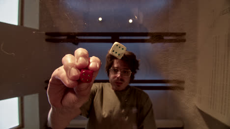 man looking at falling dice