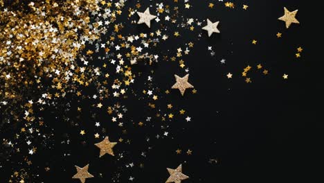 gold glitter and stars on black background