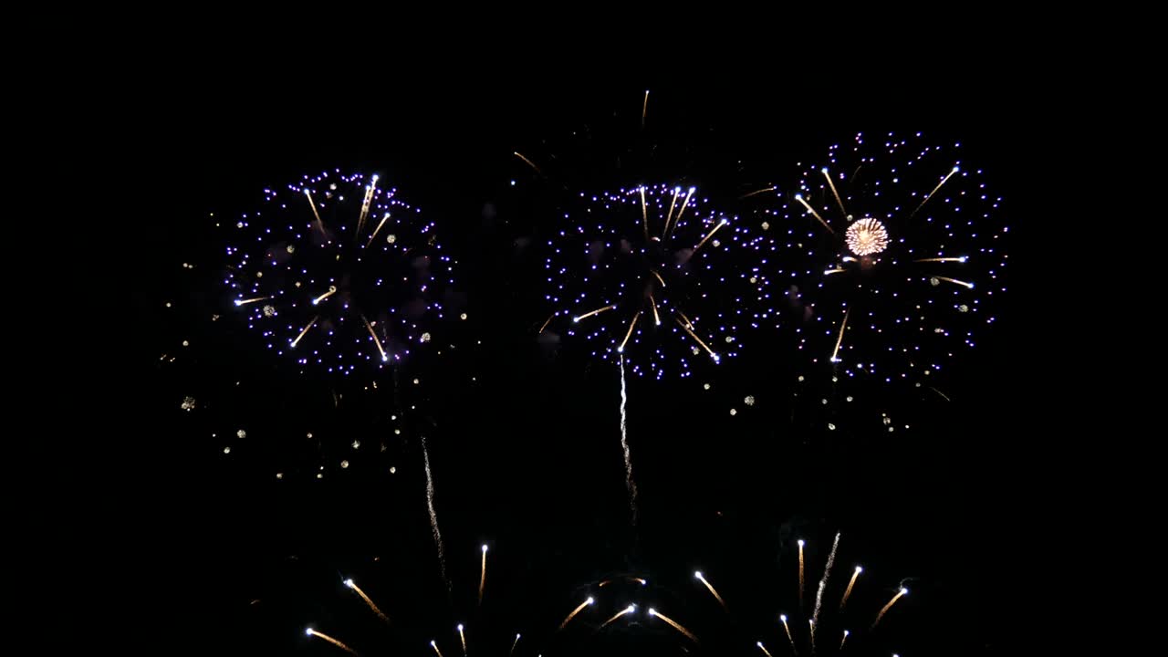 4K. seamless looping of real fireworks background during new year's eve countdown celebration, real colorful shining big fireworks festival in the sky display at night. glowing fireworks show.