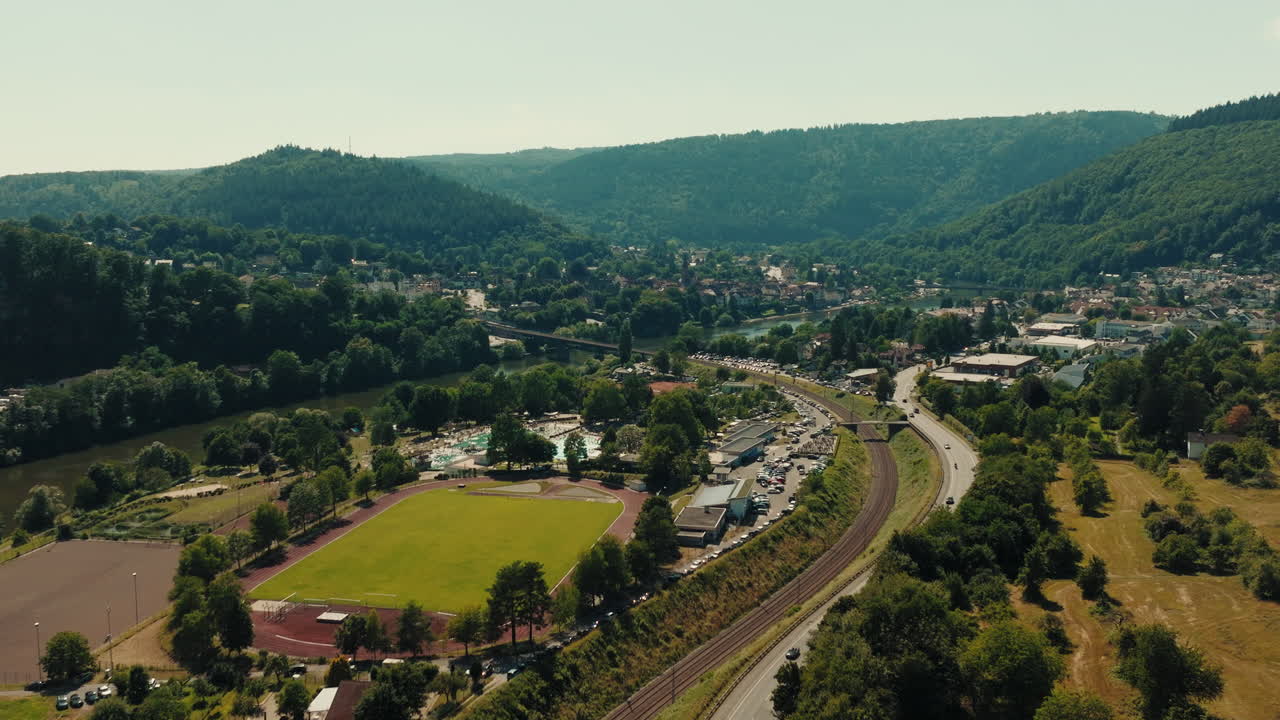 Aerial establishing shot of Odenwald with unique long roads, mountain range, and urban settlements in its valleys