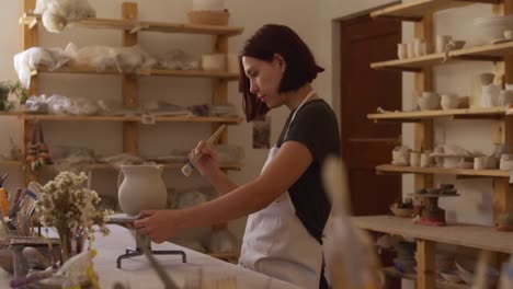 young female potter working in her studio