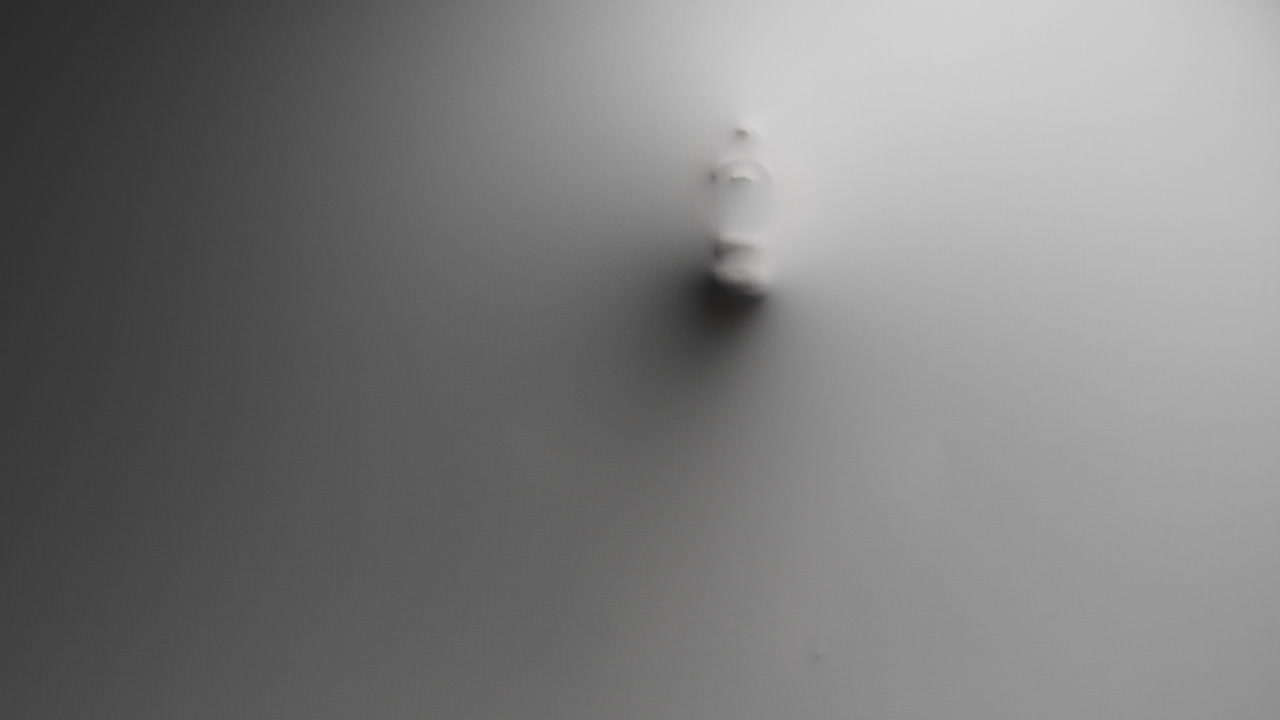 A scary silhouette of a woman appears from the white wall