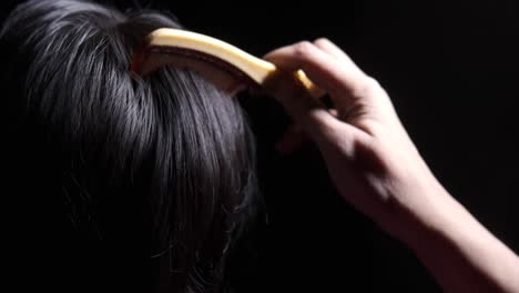 woman getting her hair combed