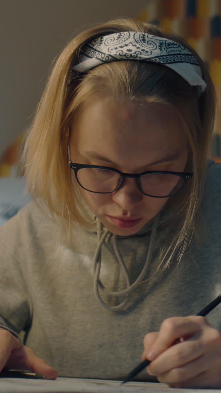 Young Woman Drawing at Home