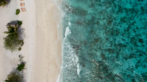 drone footage of crystal clear blue water and waves on the shore of beach in cebu philippines-5