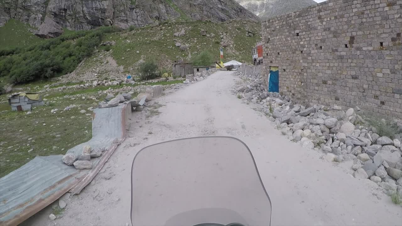 Riding over a bridge in the Himalayas with a motorbike