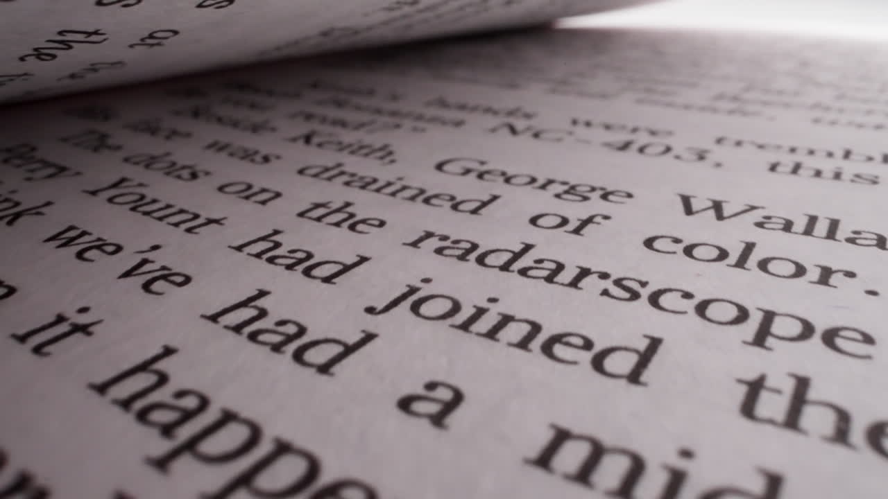 Open book with story text on page in light studio macro view