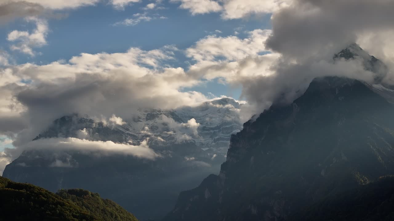Rautispitz is a peak in the Alps of the canton of Glarus, popular with climbers and hikers, offering magnificent views of the surrounding mountains and valleys. Veiled mountain peaks in clouds