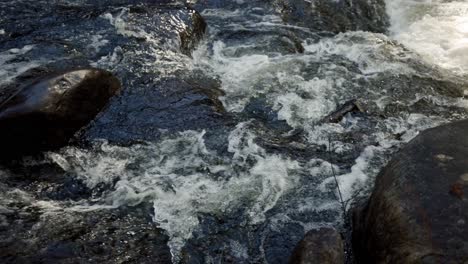 gushing river cascading over rapids and rocks in saint-côme, quebec, canada - slow motion