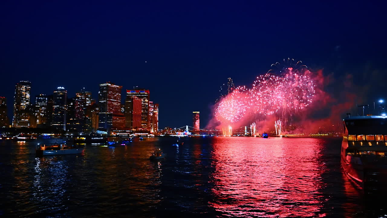 Gorgeous firework show among the night skyline of modern metropolis. Beautiful celebration in New York, USA. View from the waterscape