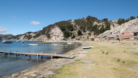 discover the serene north port of challapampa community on isla del sol, bolivia. this video captures the tranquil shores of lake titicaca, with local boats by the dock