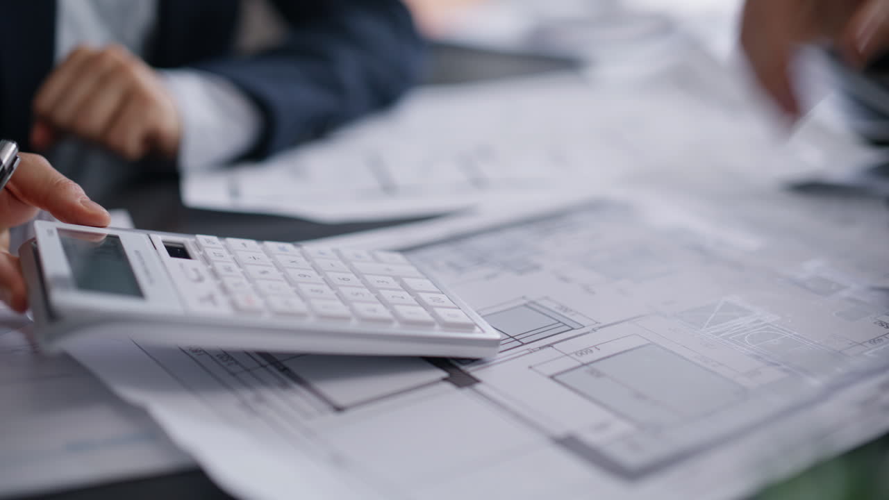 Architect hands calculating budget showing documents to customer office closeup