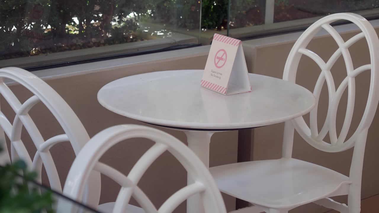 Empty Outdoor Cafe Table with No Smoking Sign