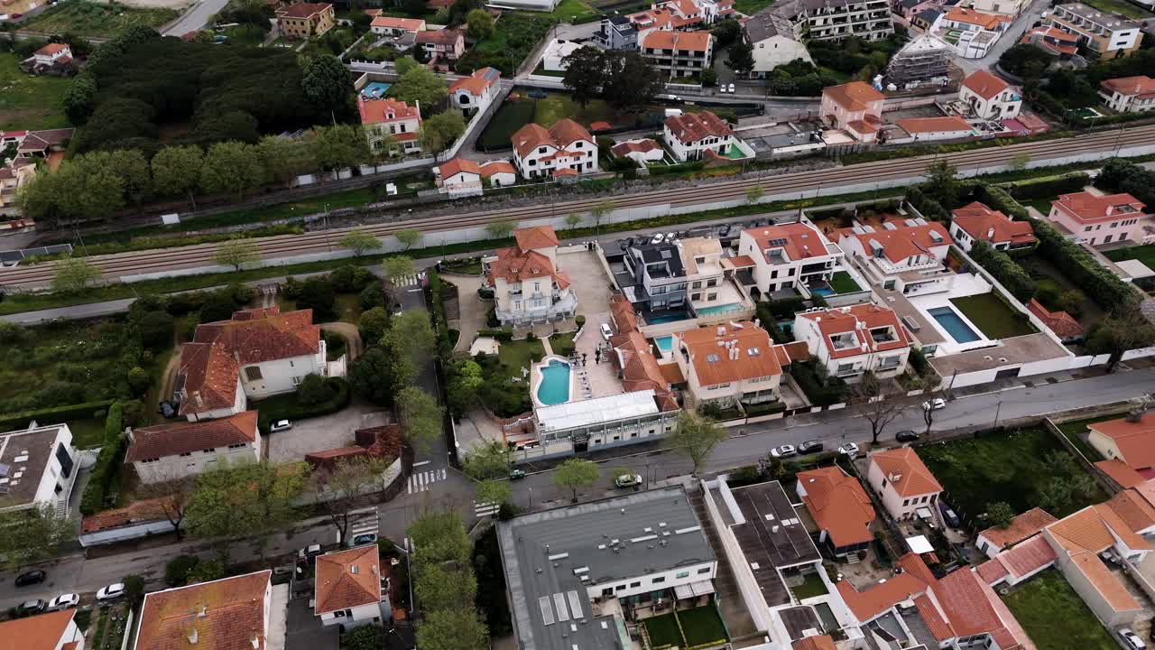 wide aerial view showing a castle style home in urban residential area