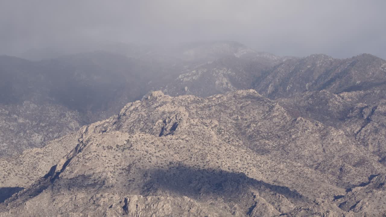 낮은 구름이나 안개가 맑은 산봉우리 위로 천천히 움직이고, 망원 샷