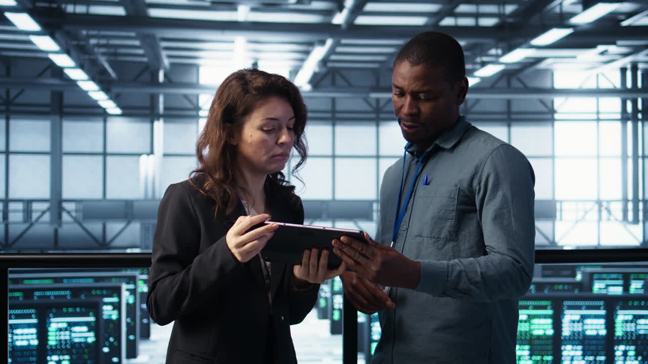 Data scientists in data center using tablet to develop disaster recovery plans