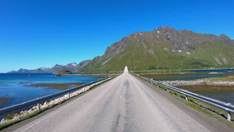 driving a car on a road in norway. vehicle point-of-view driving over the bridge.