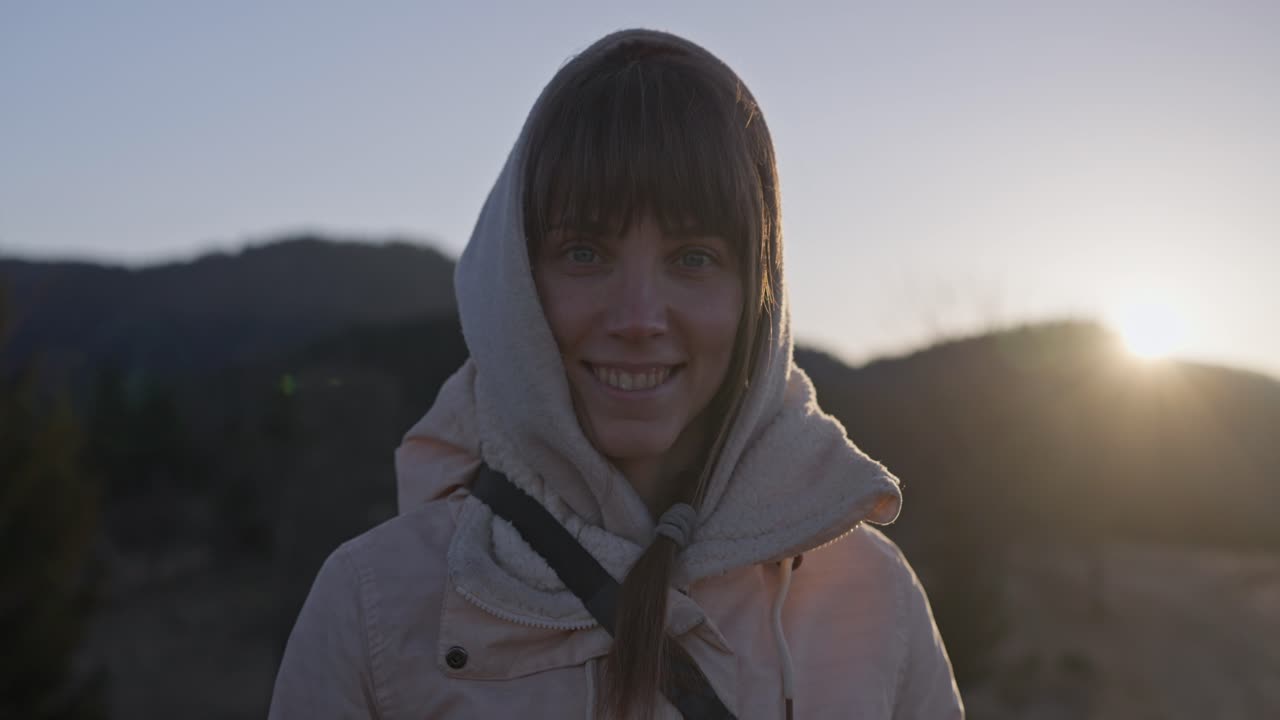Portrait of a woman in a headscarf at sunset