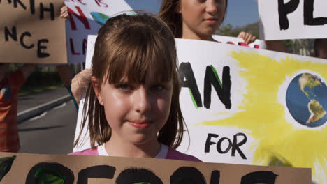 girl with climate change sign in a protest