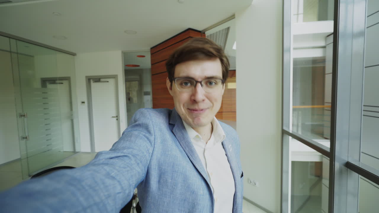 Businessman taking a selfie in an office building