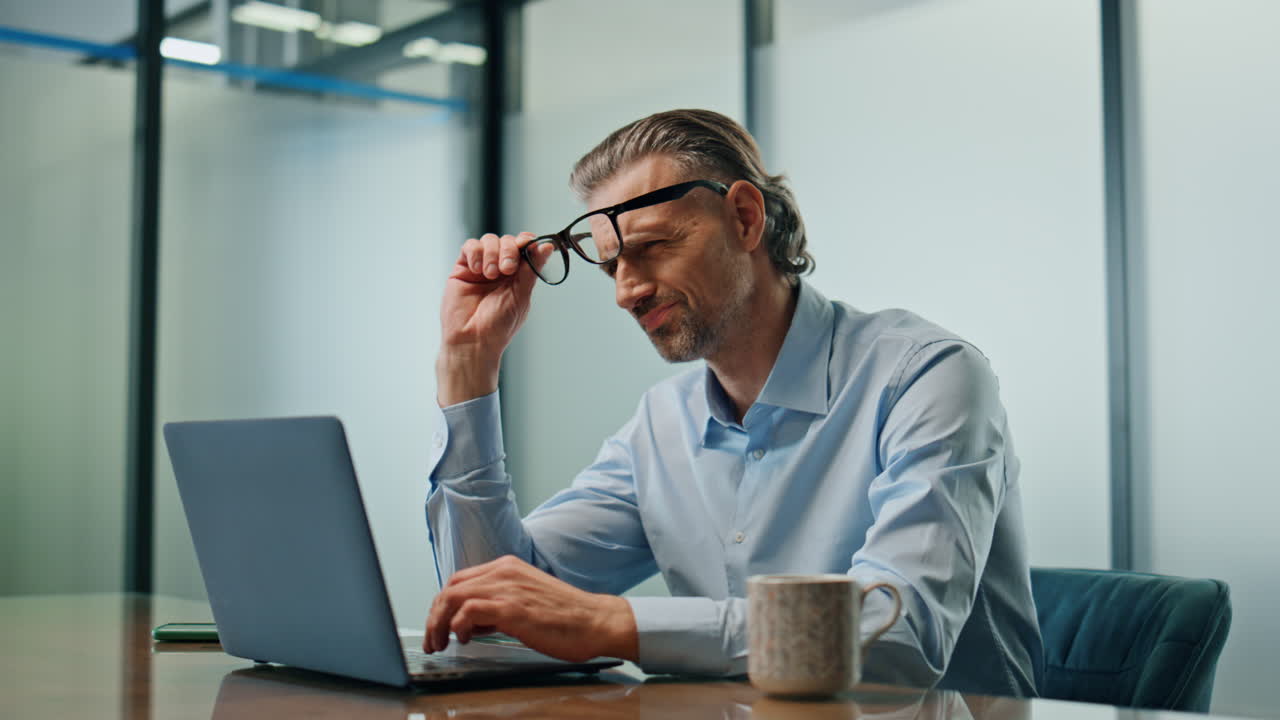 Sad businessman feeling lost cabinet closeup. Nervous man looking laptop alone