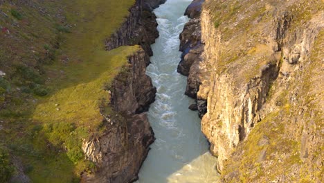 aerial view captures majesty of gullfoss falls, showcasing both nature's power and mesmerizing water flow