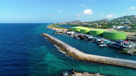 drone dolly push in to small fishing village in zakito curacao, establishing, clear blue water