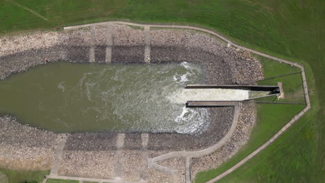 side view drone shot looking down on a lakes spillway while it is open. recorded in 4k 60fps in 10 bit 422