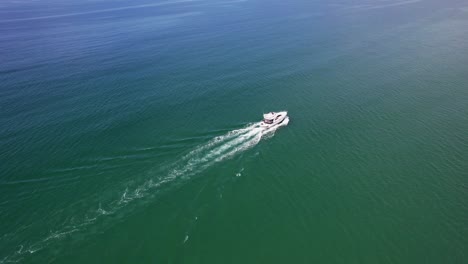 luxury fishing trawler sailing off the cornish coastal waters on a summers day, aerial drone shot