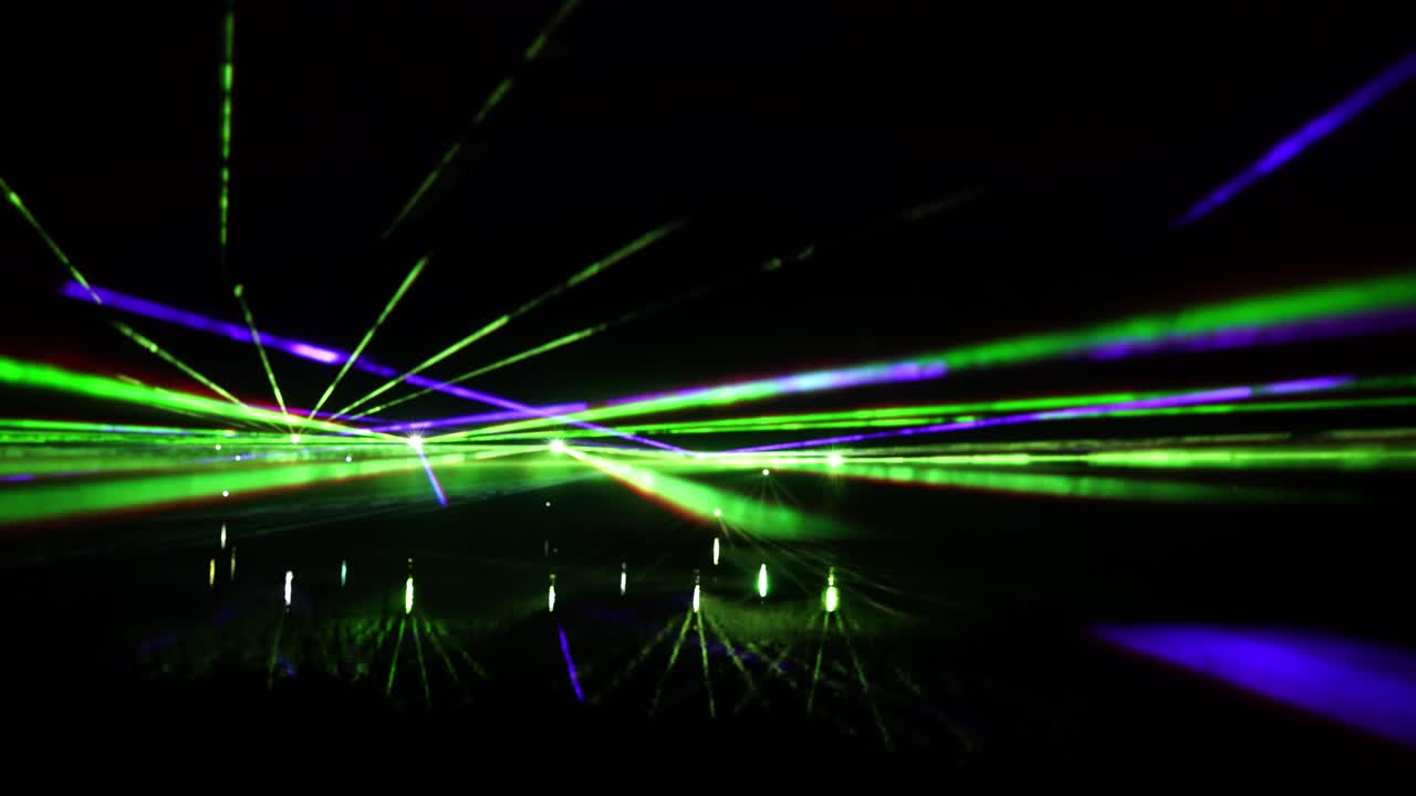 Static shot of colorful laser performance at night