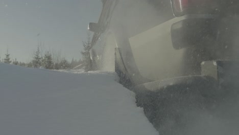 truck driving through deep snow