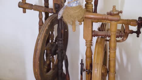 slow parallax around antique spinning wheel in abandoned house