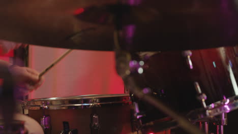 young male musician playing drums in recording studio 1