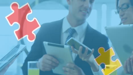 animation of colourful puzzle pieces over business people using digital devices